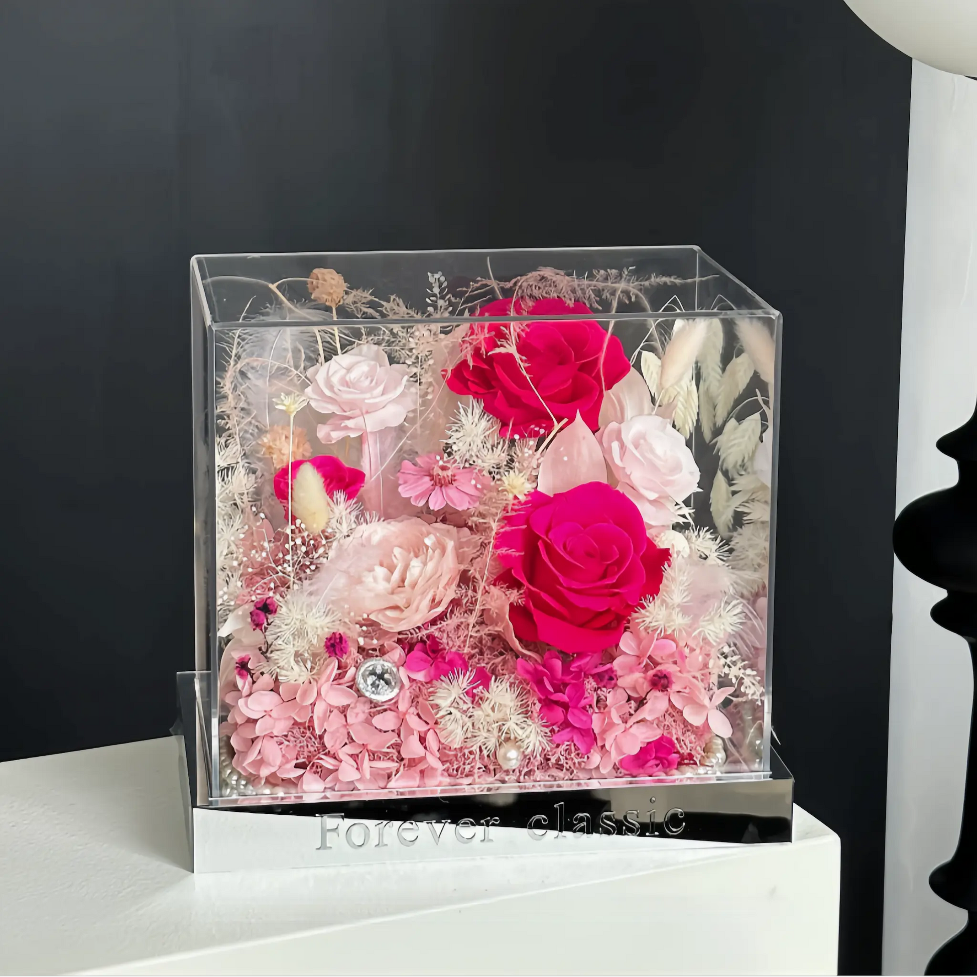 LULU ROSÉE pink flame barbie acrylic box in a chic bedroom