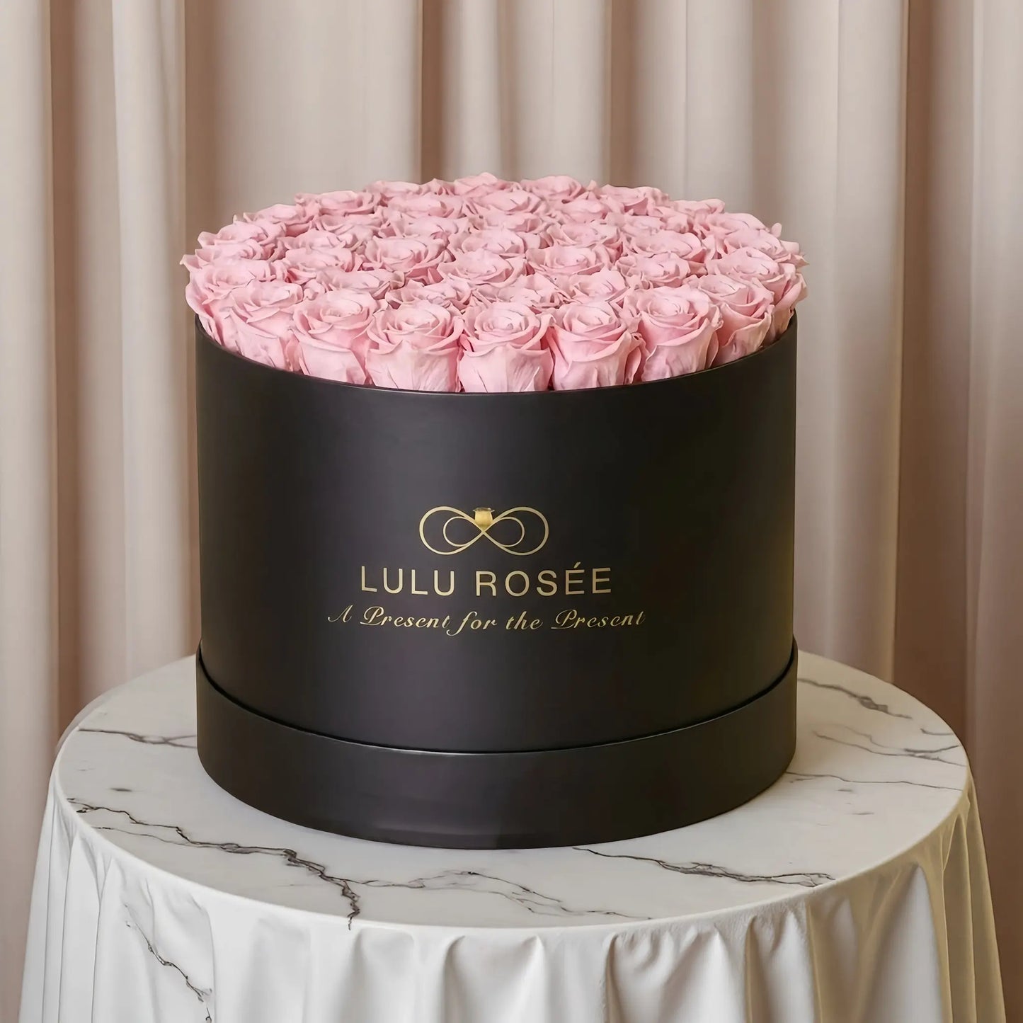 LULU ROSÉE extra large round box baby pink roses black classic box on a vanity table