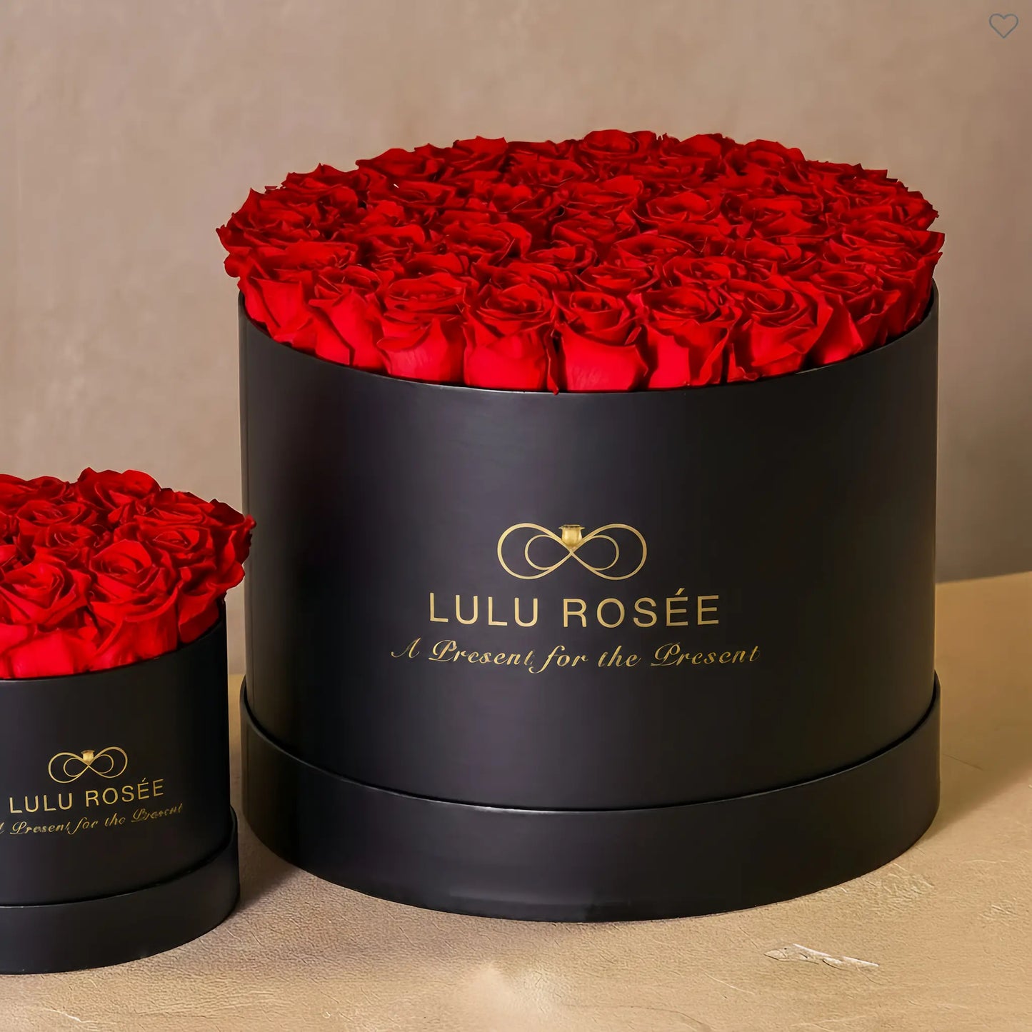 LULU ROSÉE extra large round box red roses black classic box on a beige background
