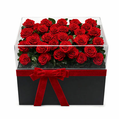 LULU ROSÉE Eternal Rose Garden 52 Red Roses in Clear Acrylic Box with Red Satin Ribbon on a white background
