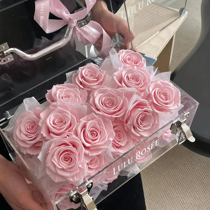 LULU ROSÉE Petite Eternal Acrylic Handbag Rose Box, small transparent acrylic handbag-shaped gift box filled with blush pink preserved roses with pink satin ribbon open lid shot, customizable flower color options, mini luxury everlasting floral souvenir for birthday, anniversary & romantic gift giving