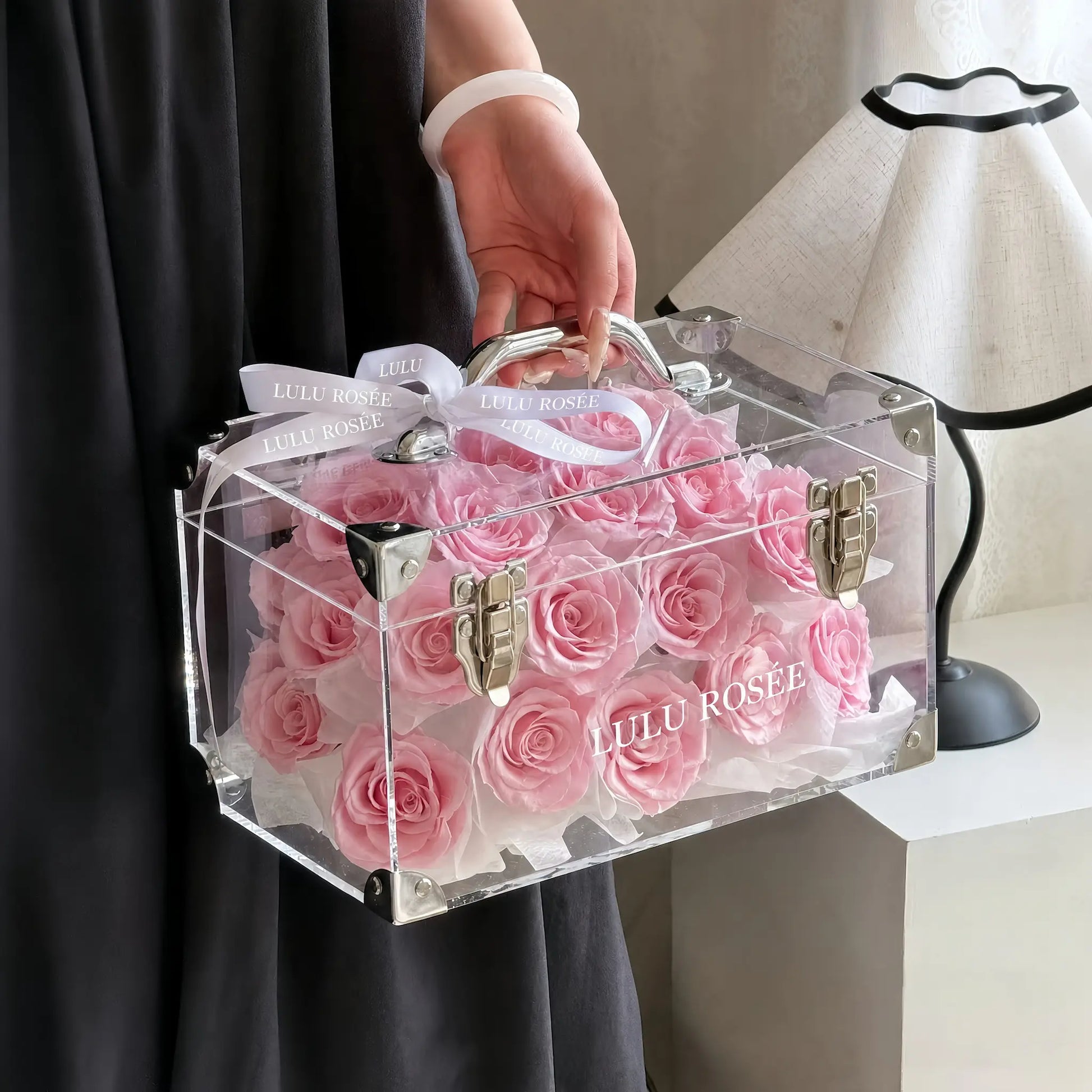 LULU ROSÉE Petite Eternal Acrylic Handbag Rose Box, small transparent acrylic handbag-shaped gift box filled with blush pink preserved roses tied with white satin bow, home interior styling shot, customizable flower color options, mini luxury everlasting floral souvenir for birthday, anniversary & romantic gift giving