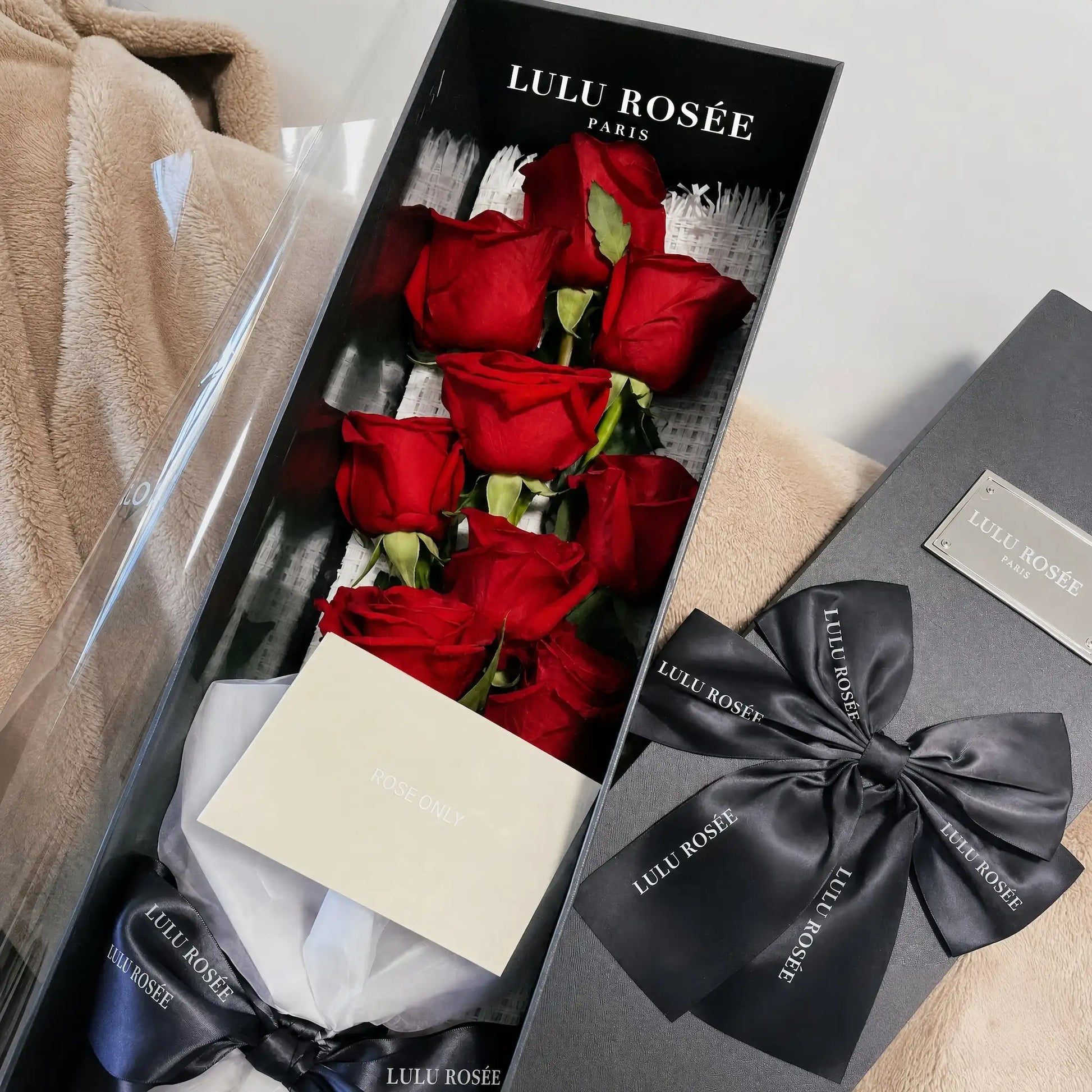 LULU ROSÉE Petite Long Stem Preserved Rose Box, luxury long rectangular gift box filled with long stem red preserved roses, open lid shot with matching greeting card, decorated with elegant grey satin ribbon, customizable flower colors, everlasting romantic floral souvenir for Valentine’s Day, anniversary & birthday gifting